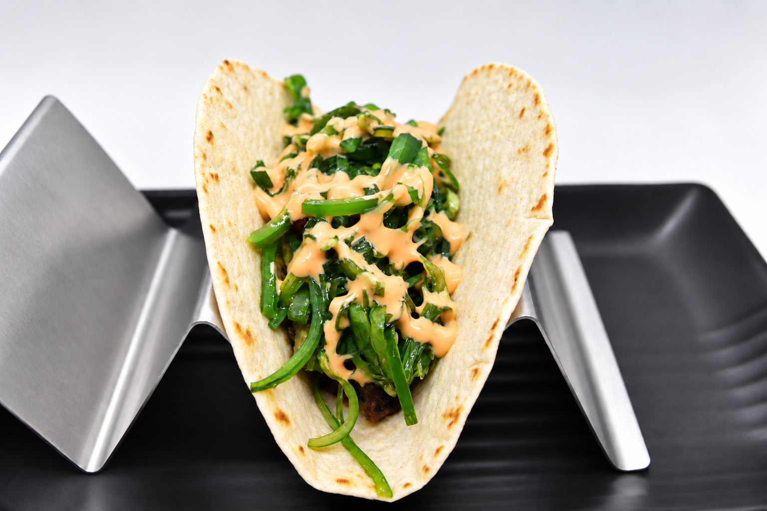 Japanese-inspired raw tuna taco with avocado and seaweed salad at The Taco 105